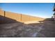 Large backyard with block wall and sandy ground at 20230 W Hollyhock St, Buckeye, AZ 85396