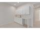 White wet bar with cabinetry and countertop at 20230 W Hollyhock St, Buckeye, AZ 85396
