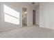 Bright bedroom with carpet flooring and access to bathroom and closet at 20230 W Hollyhock St, Buckeye, AZ 85396