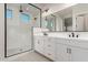 Modern bathroom with double vanity, large shower, and frameless glass enclosure at 20230 W Hollyhock St, Buckeye, AZ 85396