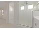 Large walk-in shower with modern tile and glass enclosure at 20230 W Hollyhock St, Buckeye, AZ 85396