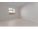 Bright and airy bedroom with tile flooring and large window at 20230 W Hollyhock St, Buckeye, AZ 85396