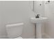 Clean and modern powder room with pedestal sink at 20230 W Hollyhock St, Buckeye, AZ 85396