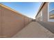 Sandy side yard with block wall and home exterior at 20230 W Hollyhock St, Buckeye, AZ 85396