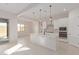 Open concept kitchen with white cabinets and breakfast bar at 20230 W Hollyhock St, Buckeye, AZ 85396