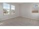 Spacious bedroom with neutral walls, carpet, and large windows at 20230 W Hollyhock St, Buckeye, AZ 85396