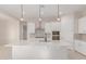 Modern kitchen island with white cabinets and quartz countertop at 20230 W Hollyhock St, Buckeye, AZ 85396
