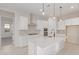Open concept kitchen with white cabinets and large island at 20230 W Hollyhock St, Buckeye, AZ 85396