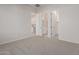 Bedroom with carpet flooring and access to bathroom and closet at 20230 W Hollyhock St, Buckeye, AZ 85396