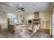 Spacious living room featuring a stone fireplace and hardwood floors at 20911 E Excelsior Ave, Queen Creek, AZ 85142