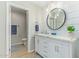 Updated bathroom with white vanity and a large mirror at 9824 W Kerry Ln, Peoria, AZ 85382