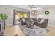 Living room with gray sectional sofa, coffee table, and patio doors at 9824 W Kerry Ln, Peoria, AZ 85382