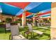 Community lounge chairs under shade sails for relaxing poolside at 9824 W Kerry Ln, Peoria, AZ 85382