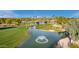 Aerial view showing a pond, golf course, and palm trees in a resort community at 9824 W Kerry Ln, Peoria, AZ 85382