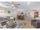 Living room with a gray sectional sofa, coffee table, and dining area at 9824 W Kerry Ln, Peoria, AZ 85382