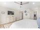 Main bedroom with dresser, ceiling fan, and access to bathroom at 9824 W Kerry Ln, Peoria, AZ 85382