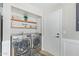 Convenient laundry area with washer, dryer, and shelving at 9824 W Kerry Ln, Peoria, AZ 85382