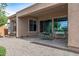 Spacious patio with table and chairs, adjacent to backyard at 26568 W Cat Balue Dr, Buckeye, AZ 85396