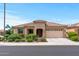 Single-story home with a two-car garage and well-manicured landscaping at 26568 W Cat Balue Dr, Buckeye, AZ 85396