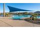 Relaxing resort-style pool with a large shade sail and comfortable seating at 26568 W Cat Balue Dr, Buckeye, AZ 85396