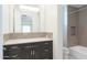 Contemporary bathroom with dark vanity, tile accents, and a bathtub at 3965 E Sierra Vista Dr, Paradise Valley, AZ 85253