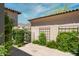 Private patio with lush landscaping and wrought iron gate at 3965 E Sierra Vista Dr, Paradise Valley, AZ 85253