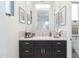 Modern bathroom with dark vanity, tile shower, and a large mirror at 3965 E Sierra Vista Dr, Paradise Valley, AZ 85253