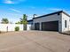 Two-car garage with modern dark wood doors and landscaping at 11905 N 83Rd Pl, Scottsdale, AZ 85260