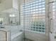 Modern bathroom with walk-in shower, built-in seat, and glass block window at 11905 N 83Rd Pl, Scottsdale, AZ 85260