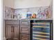 Close-up of a wet bar with wine cooler and copper accents at 11905 N 83Rd Pl, Scottsdale, AZ 85260