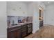 Elegant wet bar with wine cooler and granite countertops at 11905 N 83Rd Pl, Scottsdale, AZ 85260