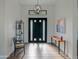 Bright entryway with a modern chandelier and contemporary furniture at 11905 N 83Rd Pl, Scottsdale, AZ 85260