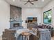 Open living room showcasing a fireplace and large window at 11905 N 83Rd Pl, Scottsdale, AZ 85260