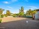 Landscaped backyard with gravel and mature trees, offering privacy and space at 11905 N 83Rd Pl, Scottsdale, AZ 85260