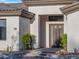 Modern home exterior with a gray double door and stone pathway at 11905 N 83Rd Pl, Scottsdale, AZ 85260