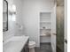 Clean bathroom with vanity, toilet, linen shelves and shower at 11905 N 83Rd Pl, Scottsdale, AZ 85260