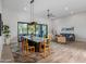 Modern dining room with a long table, contemporary chairs, and large windows at 11905 N 83Rd Pl, Scottsdale, AZ 85260