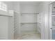 Spacious walk-in closet featuring built-in shelves and hanging rods at 11905 N 83Rd Pl, Scottsdale, AZ 85260