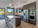 Modern kitchen with island, stainless steel appliances, and backyard view at 11905 N 83Rd Pl, Scottsdale, AZ 85260