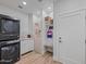 Laundry room with washer, dryer, and built-in shelving at 11905 N 83Rd Pl, Scottsdale, AZ 85260