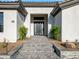 Modern home exterior with a gray double door and stone pathway at 11905 N 83Rd Pl, Scottsdale, AZ 85260