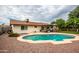 Relaxing backyard oasis featuring a sparkling pool and covered patio at 2508 W Roveen Ave, Phoenix, AZ 85029