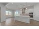 Modern kitchen with white cabinets, island, and stainless steel appliances at 20218 W Hollyhock St, Buckeye, AZ 85396