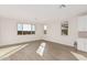 Bright living room with wood-look tile floors and large windows at 20223 W Hollyhock St, Buckeye, AZ 85396