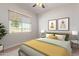 Bright bedroom with window and ceiling fan at 25843 W Northern Lights Way, Buckeye, AZ 85326