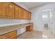Bright laundry room with wood cabinets and granite countertops at 25843 W Northern Lights Way, Buckeye, AZ 85326
