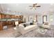 Open living room with beige sofa and view into the kitchen at 25843 W Northern Lights Way, Buckeye, AZ 85326