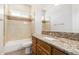 Clean bathroom with tub and granite vanity at 25843 W Northern Lights Way, Buckeye, AZ 85326