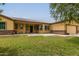 Single story house with three car garage and landscaped lawn at 25843 W Northern Lights Way, Buckeye, AZ 85326