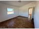 Bright bedroom with wood flooring and a view at 7801 S 547Th Ave, Tonopah, AZ 85354